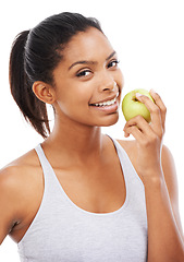 Image showing Young woman, apple and eating of healthy food for nutrition, detox and wellness in a studio portrait. Happy african person with green fruit for smile, lunch or vegan choice on a white background