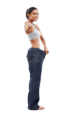 Image showing Happy woman, portrait and pointing to lose weight in jeans or decision against a white studio background. Slim female person or model smile for pick or choose in health and wellness on mockup space