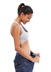 Image showing Happy woman, pants size and weight loss in diet or fitness against a white studio background. Slim young female person or model smile for thin waist, results or health and wellness on mockup space