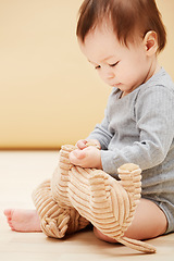 Image showing Baby, stuffed animal and playing in home for comfort care, childhood development or game entertainment. Kid, toy teddy and learning in apartment for education progress, coordination, growth or youth
