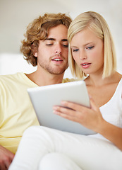 Image showing Research, tablet and young couple on sofa browse on social media or internet at apartment. Happy, digital technology and man and woman from Australia relax and scroll on website in lounge at home.