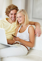 Image showing Happy couple, credit card and laptop for home online shopping, loan and digital money on a sofa. Young woman and man on computer for internet banking, easy website payment or e commerce registration