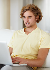 Image showing Laptop, remote work and man on a sofa for research, planning or web communication in his home. Tech, freelance and male entrepreneur online in a living room with social media, search or streaming