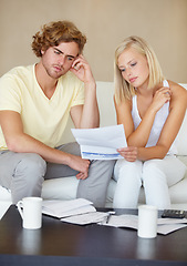 Image showing Sad couple, bills and documents stress on sofa in debt, financial planning and budget risk or worry at home. Young woman and man with depression, reading paper and loan, bankruptcy or mortgage letter