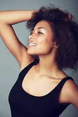 Image showing Woman, afro and hair care for natural beauty in studio or curly treatment, grey background or mockup space. Female person, smile and grooming confidence or healthy wellness, texture pride or volume