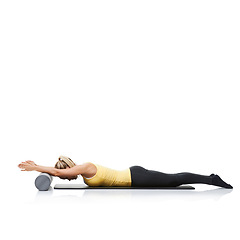 Image showing Stretching, foam roller and woman in a studio for exercise, wellness or gym routine with yoga mat. Stability, balance and young female athlete from Australia with body workout by white background.
