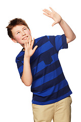 Image showing Shock, hands raised and child with hiding, shield and protection looking up in a studio. Young boy, fashion and modern clothing with youth and scared from mockup with white background with kid