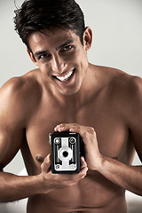 Image showing Shirtless, man and portrait with vintage camera for sexy, photography or recording happiness. Muscular, model and smile with retro photographer, hobby or topless person with creative film project