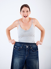 Image showing Woman, lose weight and portrait of surprise with jeans, change in size or white background in studio. Wow, shocked and person with crazy transformation in fitness, health or comparison in denim pants