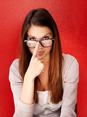 Image showing Portrait, woman and fix glasses for vision, optometry and eye care health isolated on a red studio background. Face, person adjust spectacles and frame, prescription lens correction or ophthalmology