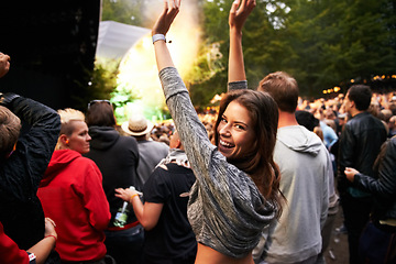 Image showing Happy woman, portrait and crowd in music festival for party, event or DJ concert in nature. Excited female person smile with hands up and audience at carnival, performance or summer fest outside