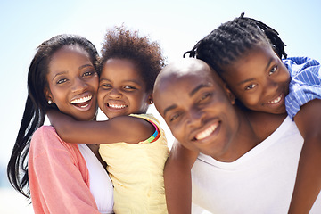 Image showing Portrait, piggyback and a black family on the beach in summer together for travel, freedom or vacation. Love, smile or happy with a mother, father and children on the coast for holiday or getaway