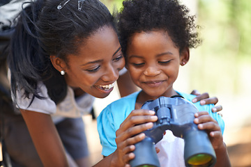 Image showing Happy, binocular or black family hiking in forest to relax or bond on holiday vacation together in nature. Child, sightseeing or African mom in woods or park to travel on outdoor adventure with smile