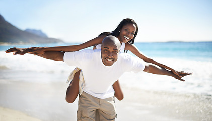 Image showing Black couple, smiling and piggyback with portrait, beach and married for summer vacation. African, enjoying and happy for holiday, fun and seaside in outdoor, beautiful and day off in costal city