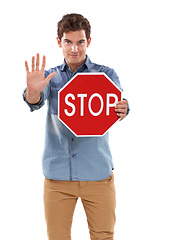 Image showing Portrait, man and traffic stop sign, hand and studio isolated on a white background mockup space. Person show red octagon symbol, palm and danger warning, forbidden caution or prohibition in security