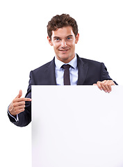 Image showing Pointing, smile and businessman with poster in a studio with mockup space for marketing, promotion or advertising. Happy, handsome and male person from Canada with empty sign by white background.