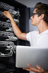 Image showing Server room, information technology and man with laptop, check connectivity and night job. Cybersecurity system, it network or person for internet, data center and storage with cables for database