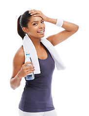 Image showing Woman, water and sweat in portrait for fitness, studio and liquid for health and wellness. Happy athlete, female person and pride on face for hydration, weight loss and detox by white background