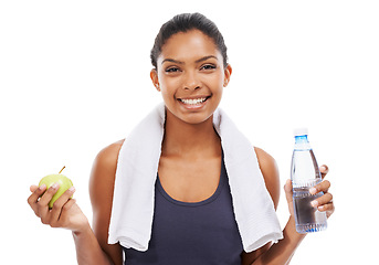 Image showing Portrait, apple and water for fitness with a woman in studio isolated on a white background for health. Exercise, smile and towel with a confident young athlete at the gym for training or nutrition