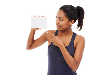 Image showing Smile, space and a woman pointing to an empty card in studio isolated on a white background for information. Advertising, marketing or contact us with a happy young person holding a piece of paper