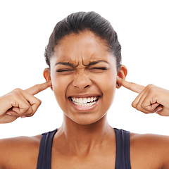 Image showing Face, sound and fingers in ears with an eyes closed woman in studio isolated on a white background. Stress, anxiety or loud with a frustrated young person feeling unhappy or overwhelmed by noise