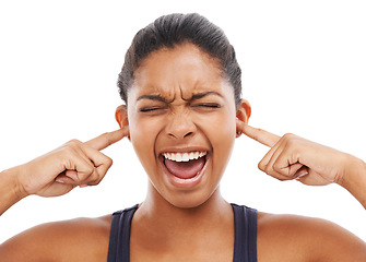 Image showing Face, shouting and fingers in ears with a woman in studio isolated on a white background to block sound. Frustrated, screaming and eyes closed with an angry young person closeup to stop loud noise