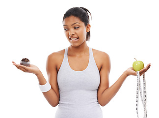 Image showing Woman, apple and cupcake decision for diet in studio for weight loss choice, healthy eating or white background. Female person, fruit and dessert thinking for nutrition food, balance or mockup space