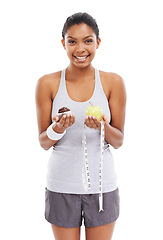 Image showing Woman, portrait and cupcake or apple choice in studio or healthy decision, diet balance or white background. Female person, dessert and fruit or tape measure as weight loss, mockup space or nutrition
