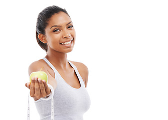 Image showing Woman, portrait and lose weight with a measuring tape and apple in white background, studio or mockup. Happy, model and healthy food for results in fitness, wellness and diet with nutrition and fruit