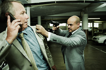 Image showing Business man, parking lot and gun for crime, robbery or kidnap with horror, mafia and negotiation on a phone call. Corporate boss, manager or person talking on mobile with gangster for ransom or debt