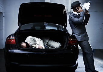 Image showing Crime, car and man with hostage in trunk for negotiation, kidnapping ransom and phone call. Mafia, gangster criminal and businessman smoking in boot for abduction, danger and robbery in parking lot
