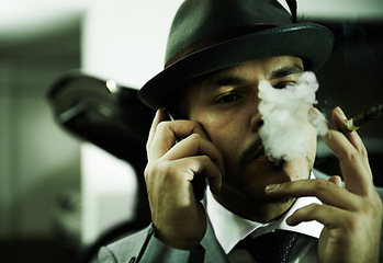 Image showing Man, gangster and phone call while smoking or planning mafia, danger or ransom abduction. Male person, cigar and mobile device or hitman conversation for robbery violence, interrogation or terror