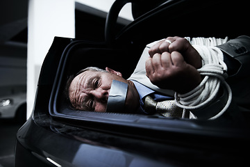 Image showing Man in trunk of car, kidnap and danger with violence, fear and rope in basement garage with shock. Crime, human trafficking and scared person tied in dark parking lot with risk, terror and robbery.