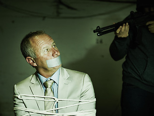 Image showing Business man, kidnap and hands with gun for crime, ransom and negotiation in terror, abduction or danger at night. Criminal, scared person or mature hostage in fear, tied up and duct tape in shooting