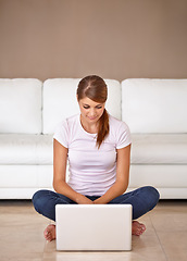Image showing Woman, remote work and laptop on floor in home to update blog post, social media and reading digital news subscription. Freelancer, computer and relax on ground for online shopping, email or research