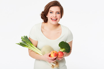 Image showing Woman, happy and portrait with vegetables in studio, nutrition and wellness for vegan diet in mock up. Person, smile face and fruit for food, vitamins and detox in nutritionist by white background