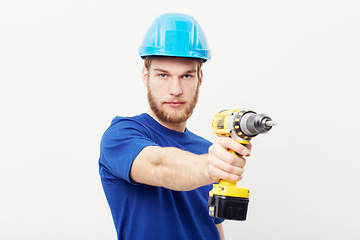 Image showing Construction worker man, power drill and studio portrait with hand for maintenance by white background. Person, employee or small business owner with tools, helmet and job at repair services company