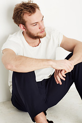 Image showing Thinking, depression and man on a floor with stress, anxiety or broken heart disaster in his home. Overthinking, crisis and sad male person on the ground with grief disaster, mistake or mourning loss