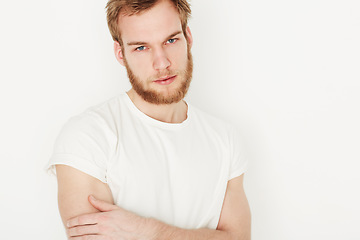 Image showing Man, portrait and confident or fashion in studio with casual style, trendy outfit and calm expression. Person, face and relaxing, t-shirt and satisfaction with peace and pride on white background