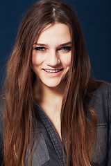 Image showing Portrait, beauty and smile with a natural woman in studio on a dark background for wellness at the salon. Face, hair or skincare and a confident young model looking happy with makeup or cosmetics