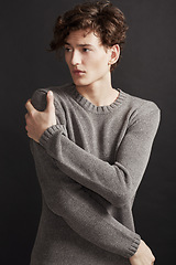 Image showing Serious, fashion and man in sweater thinking in studio isolated on a a grey background. Model, idea and dream in style, trendy clothes and young, handsome or casual insecure person on a backdrop