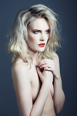 Image showing Beauty, nude and woman on blue background with makeup, cosmetics and red lipstick in studio. Model, aesthetic and person with frizzy hairstyle, naked and sexy with confidence, pride and art deco