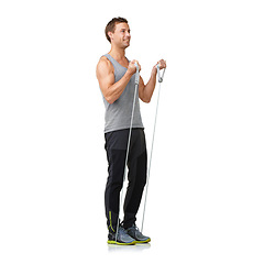 Image showing Stretching, man and resistance band for exercise in studio, gym and performance in strong muscles. Sports person, smile or fitness in commitment by equipment, mockup or cardio by white background