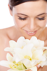 Image showing Happy woman, relax and flowers for skincare beauty in cosmetics or makeup against a white studio background. Face of female person smile with nature bloom, blossom or bouquet for natural skin glow