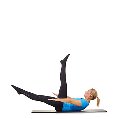 Image showing Woman, pilates and mat in studio for stretching legs, fitness or workout for healthy body, wellness or core muscle. Person, exercise or yoga on floor for abdomen on mockup space or white background