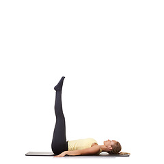 Image showing Woman, pilates and mat in studio for stretching legs, fitness or workout for healthy body, wellness or core muscle. Person, exercise and yoga on floor for abdomen on mockup space and white background