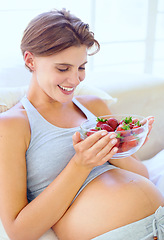 Image showing Pregnant woman, strawberry and nutrition in bedroom with relax wellness for eating fruit in house. Young person, happy and prenatal health diet with natural food for vitamins and care in apartment