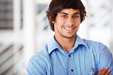 Image showing Portrait, smile and a business man arms crossed in his office for an internship as a confident designer. Face, mindset and a happy young employee in a company workplace or startup design agency