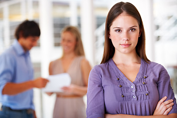 Image showing Office, crossed arms and portrait of business woman with team for leadership, confidence and pride. Marketing agency, company and serious worker with staff for meeting, planning and collaboration