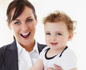 Image showing Happy, baby and mom in portrait with business, work and motherhood with a professional career. Mockup, space and woman in a suit smile with love, care and playing with child in home or morning